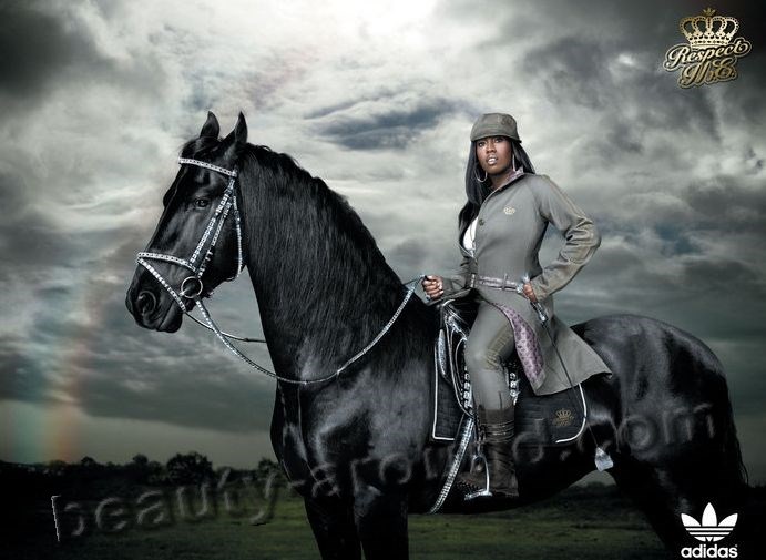 Missy Elliott sits astride on a beautiful black horse photos